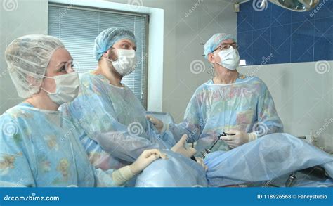 Team of Doctors Working Together during a Surgery in an Operating Room at a Hospital Stock Photo ...