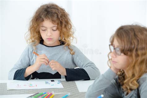 Two School Aged Girls Sat at Table Drawing Pictures Stock Image - Image of childhood, little ...