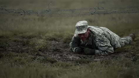 Soldiers crawling in mud, under a barbed wire obstacle course. At training. - YouTube