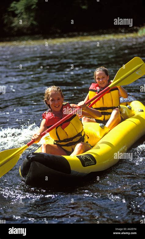 two girls kayaking on the river Kennebec Maine USA after taking a ducking Stock Photo - Alamy