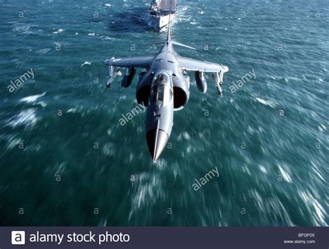 Royal Navy Sea Harrier with HMS Invincible in the background Stock ...