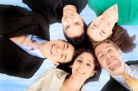 business teamwork - heads together over a technology blue background | Freestock photos