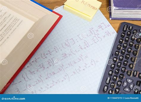 A Student is Doing Math Homework with a Calculator and an Open B Stock Photo - Image of table ...