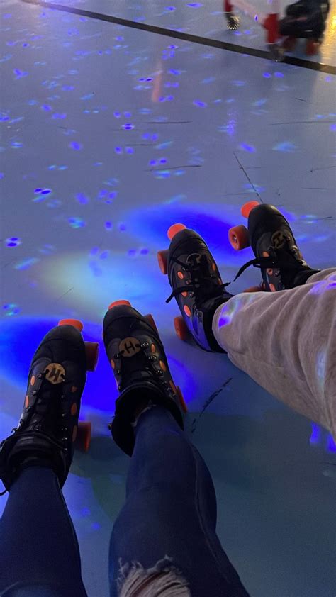 two people riding skateboards on top of an ice covered floor with blue ...