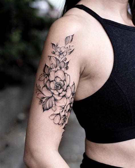 A black floral piece on the right upper arm | Tattoos for women half sleeve, Unique half sleeve ...