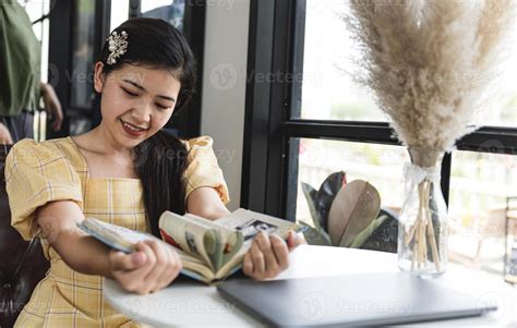 Girl is reading book beside window. 13899548 Stock Photo at Vecteezy