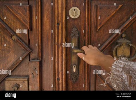 Hand Opening Wooden Door With The Lock Stock Photo - Alamy