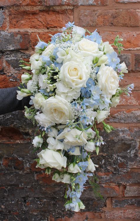 cascading bridal bouquet in pale blue and ivory flowers - avalanche roses - blue delphinium ...