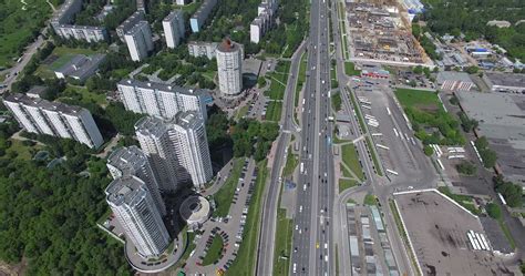 An aerial view of a busy highway next to the multi storey district ...