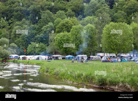 Camping with campfires along the Semois river in the neighborhood of ...