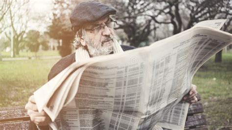 Old Man Reading Newspaper in the Park Stock Image - Image of winter, city: 143823567