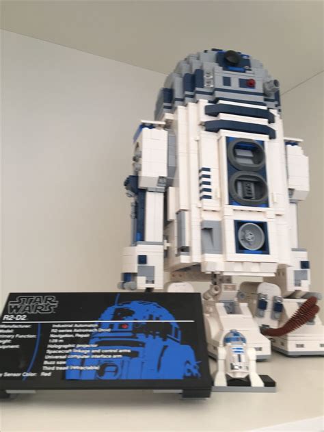 a lego r2d2 is sitting on a table next to a star wars book