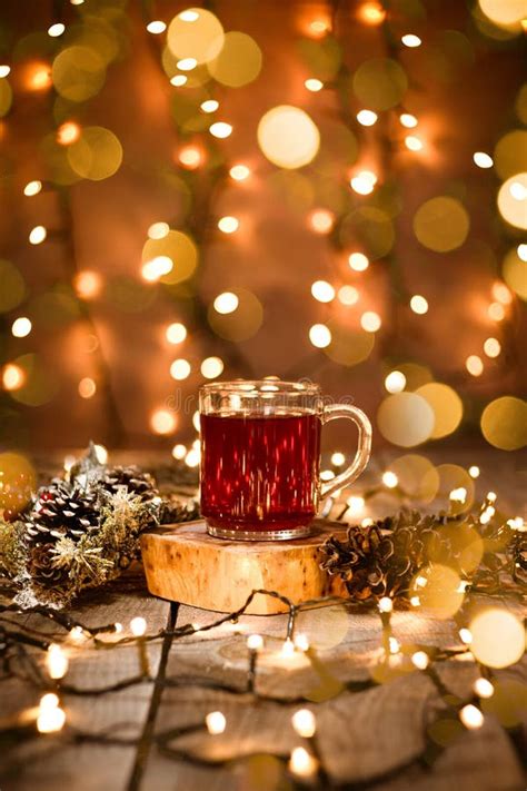 Holiday Scene of Fruit Tea in a Glass Mug with Decoration and Bokeh Lights on a Wooden Table and ...