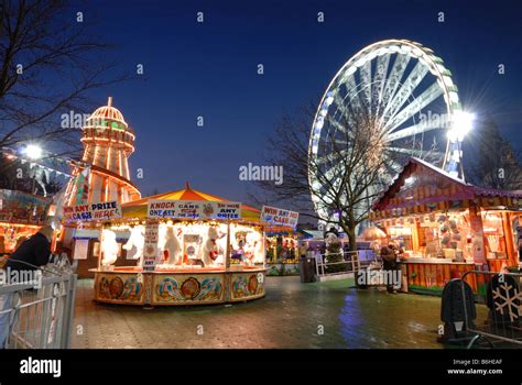 Cardiff Winter Wonderland's carousels and funfair in front of the "Admiral Eye Stock Photo - Alamy