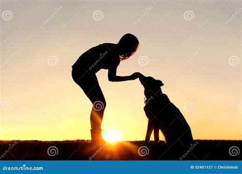 Woman Feeding Pet Dog Treats Silhouette Stock Photo - Image: 52401127