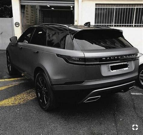 the range rover is parked in front of a garage with its door open and it's hood up