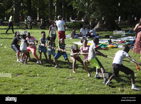 Both children and parents play tug of war game at a picnic in Stock Photo: 111739737 - Alamy