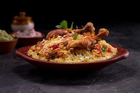 Premium Photo | Chicken biriyani using jeera rice arranged in an ...