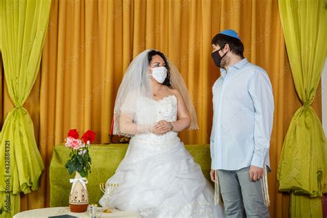 During the chupa ceremony in the synagogue, the masked Jewish bride and ...