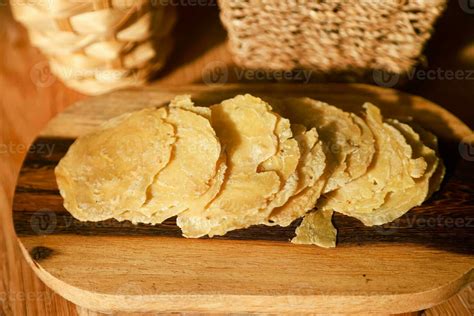 Raw melinjo crackers are placed on a wooden tray before being fried 27421125 Stock Photo at Vecteezy