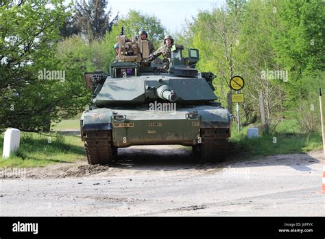 A Danish tank crew member (left) and Spc. Alexander Kefford, a tank ...