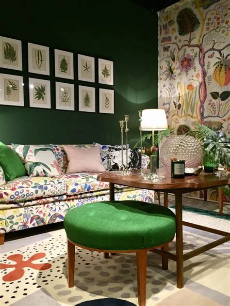 24-a-whimsical-living-room-with-an-emerald-accent-wall-and-a-floral-one-a-crazy-floral-sofa-and ...