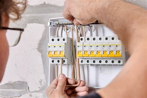 Premium Photo | Connecting home wiring to fuse box in consumer unit of switchboard