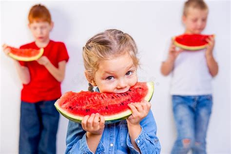 Kids eating watermelon stock image. Image of cutting - 105635933