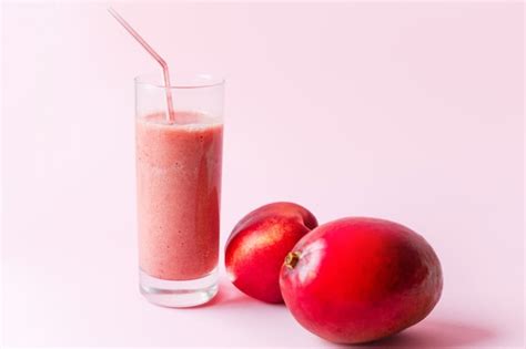 Premium Photo | Fresh pink smoothie with peach and mango