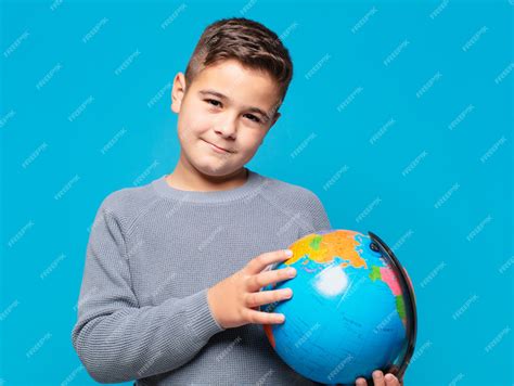 Premium Photo | Little boy happy expression and holding a world map model