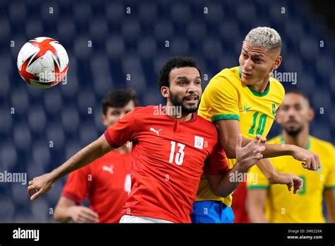 Egypt's Karim Eraky, left, and Brazil's Richarlison fight for the ball ...