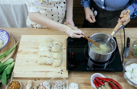 Crop unrecognizable women boiling noodles and cooking together · Free ...