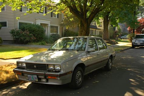 OLD PARKED CARS.: 1982 Cadillac Cimarron.