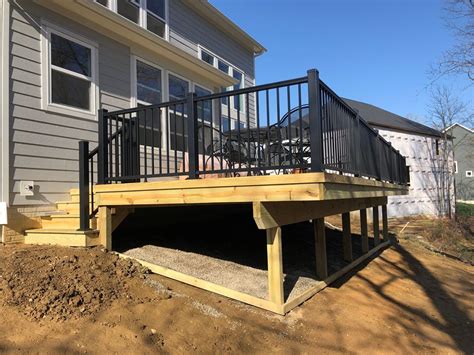 Wooden deck designs with low maintenance railing.