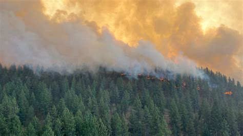 Thousands under evacuation orders and some homes burn as wildfires race ...