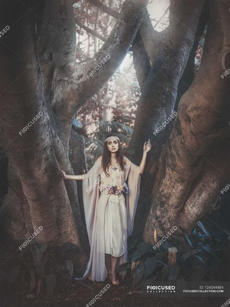 Brunette woman standing barefoot in forest — long hair, person - Stock Photo | #124044484