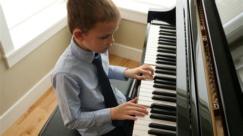 A Charming Child Performs Piano At Home Stock Footage SBV-338133994 ...