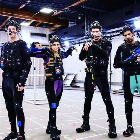 three men in scuba suits are posing for the camera with their hands on their hipss