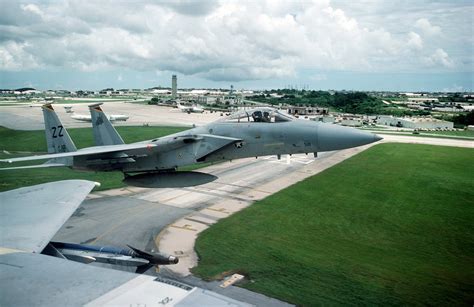 Right side view of an F-15 Eagle aircraft taking off. Visible in the foreground is a portion of ...