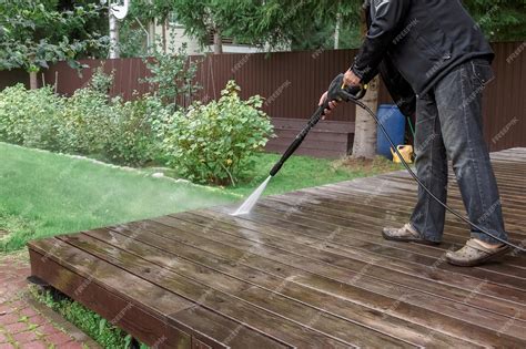 Premium Photo | Man cleaning walls and floor with high pressure