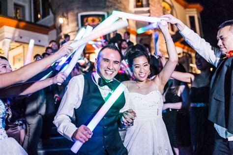 Bride and Groom Gracefully Exit Under a Foam Glow Stick Arch