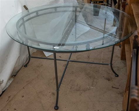 Lot 243 - A circular dining table with a glass top on