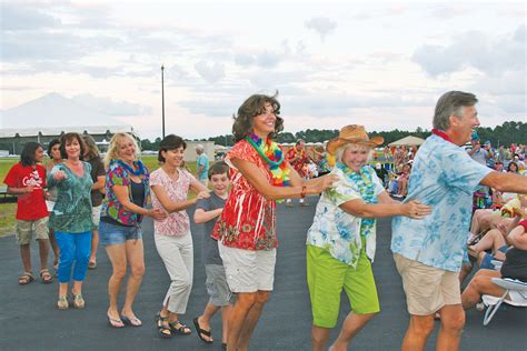 Folks dance the conga line during last year's Phlock to the Beach outdoor concert. Courtesy photo