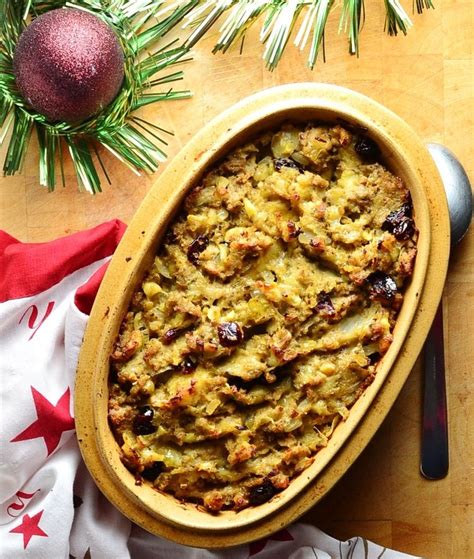 a casserole dish with meat and vegetables in it on a table next to ...