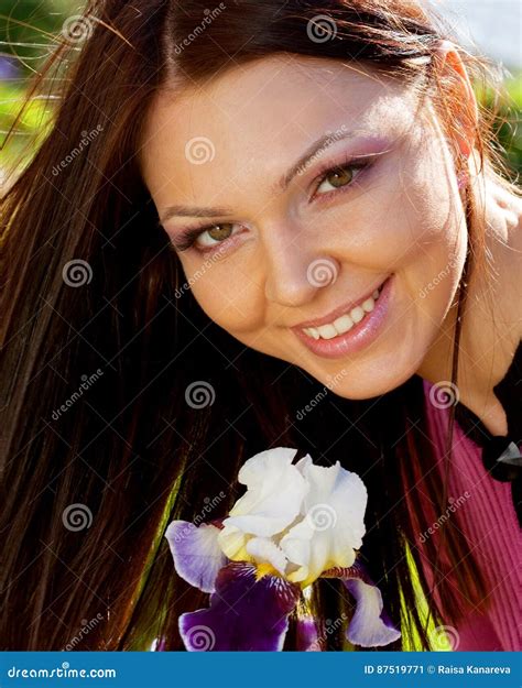 Woman Smiling Outdoors with Some Flowers Stock Image - Image of lifestyle, happiness: 87519771