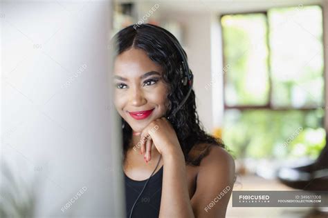 Young woman with headset working from home at computer — home office, service - Stock Photo ...