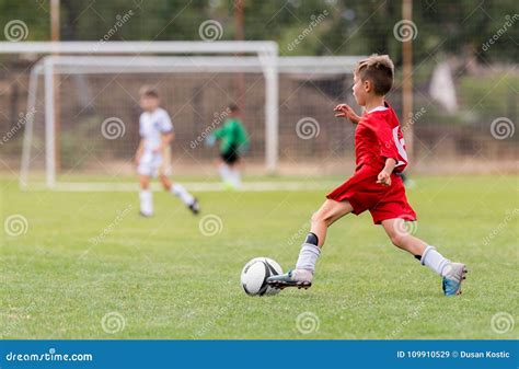 Boy Kicking Football on the Sports Field Stock Image - Image of play ...