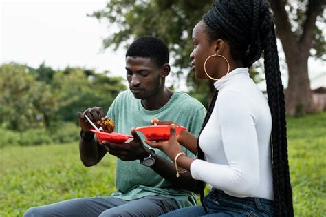 Premium Photo | Medium shot nigerian people with food