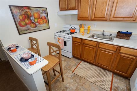 Fully equipped kitchen with counter seating at Cheverly Station Apartments, High Quality ...