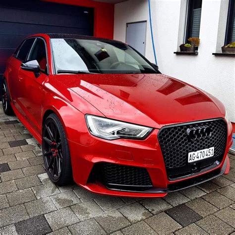 a red car parked in front of a house